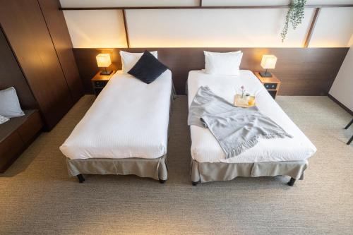 Postel nebo postele na pokoji v ubytování KABIN Kyoto