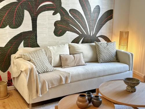 a living room with a couch and a table at La Maison Cavet 5 Appartements de standing au cœur du village in Sanary-sur-Mer