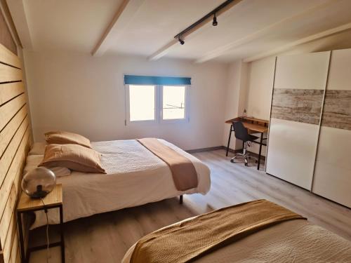 a bedroom with two beds and a desk at WHITE House in Burgos