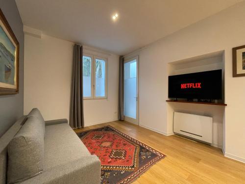 a living room with a couch and a tv at Luxury Pisu Apartments in Quartucciu
