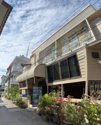 a building with potted plants on the side of it at King's Home Hua Hin Homestay in Hua Hin