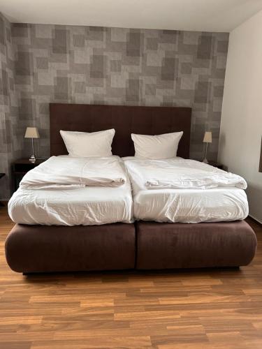 a bed with two pillows on it in a room at Alte Schlosskurve Hotel & Restaurant in Bad Arolsen
