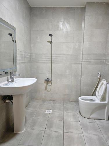 a bathroom with a sink and a toilet at AL Sahab Tower in Manama