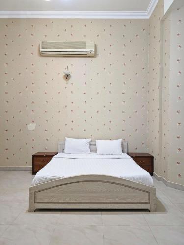 a bedroom with a bed with a air conditioner on the wall at AL Sahab Tower in Manama
