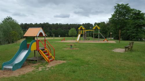 a park with a playground with a slide at Tipi Cheyenne des monteaux in Vivy