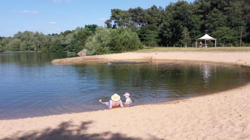 two children playing in the water on the beach at Tipi Cheyenne des monteaux in Vivy