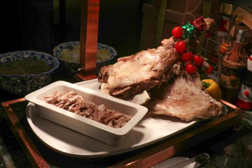 a plate of food with a bowl of meat and berries at Crowne Plaza Suzhou East Taihu by IHG in Suzhou