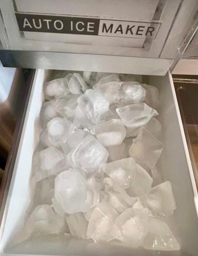 a refrigerator filled with lots of ice cubes at Raven's Peak 105 - Ultra luxe Mountain Retreat in Canmore