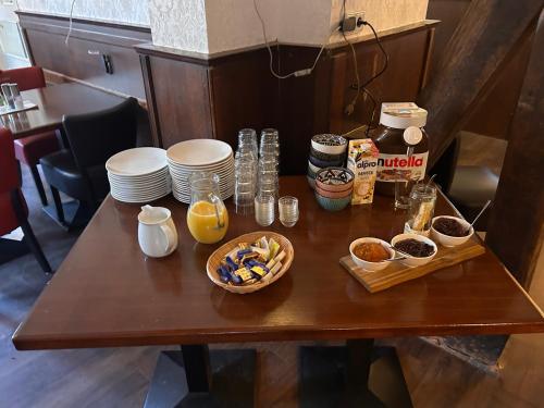 a table with plates and bowls of food on it at Alte Schlosskurve Hotel & Restaurant in Bad Arolsen