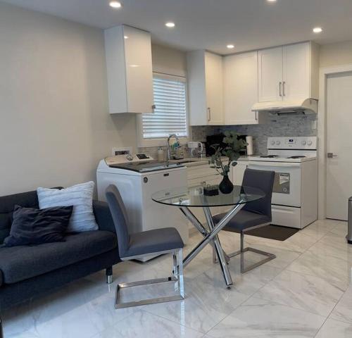 a kitchen with a couch and a table in a kitchen at Modern Spacious 1BR minutes away from Main St in Vancouver