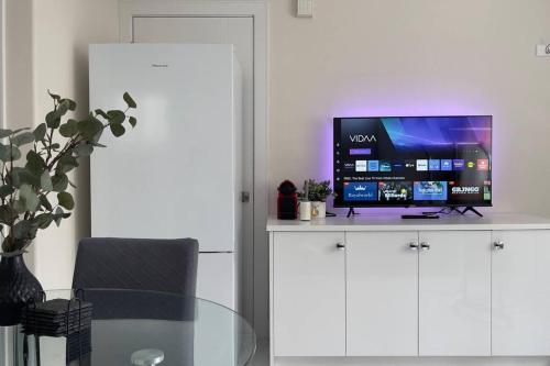 a living room with a tv on a white cabinet at Modern Spacious 1BR minutes away from Main St in Vancouver