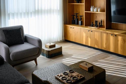 a living room with a couch and a chair at Oaks Hotel  in Golan Heights
