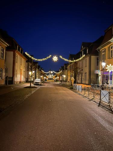 an empty street at night with a string of lights at Alte Schlosskurve Hotel & Restaurant in Bad Arolsen