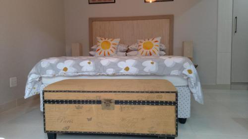 a bedroom with a bed with two pillows on it at 81 A & Away Studio apartment West Wing in Mossel Bay