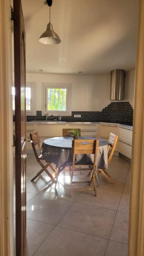 une cuisine avec une table et des chaises dans une pièce dans l'établissement Villa architecte Tamaris sur mer, à La Seyne-sur-Mer