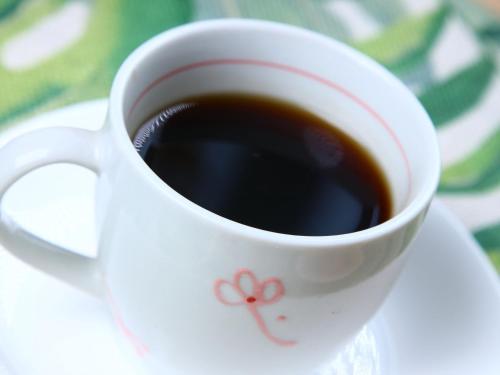 a white cup of coffee on a plate at MAETAKAYA しまんちゅ in Ishigaki Island