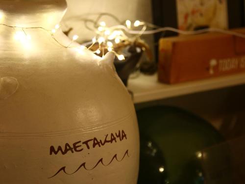 a white vase with the word mediterraneanemia written on it at MAETAKAYA しまんちゅ in Ishigaki Island