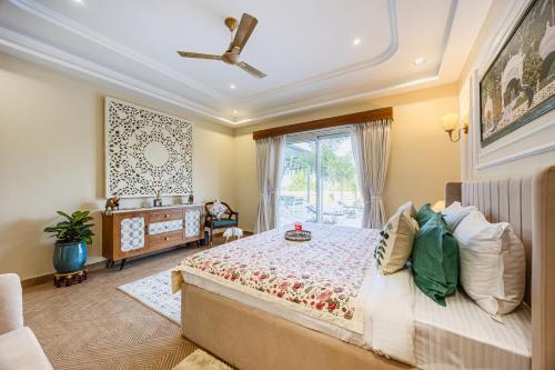 a bedroom with a large bed and a window at ELIVAAS Heaven in Hills Mountara 3 BHK Villa with Lounge & Pvt Pool in Udaipur