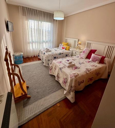 a bedroom with two beds and a large window at Rincon Azul in Arcade