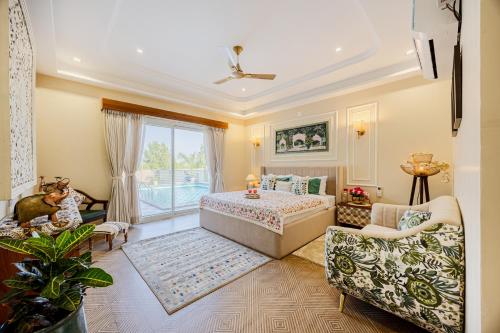 a bedroom with a bed and a living room at ELIVAAS Heaven in Hills Mountara 3 BHK Villa with Lounge & Pvt Pool in Udaipur