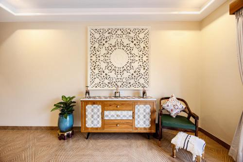 a room with a table and a chair at ELIVAAS Heaven in Hills Mountara 3 BHK Villa with Lounge & Pvt Pool in Udaipur