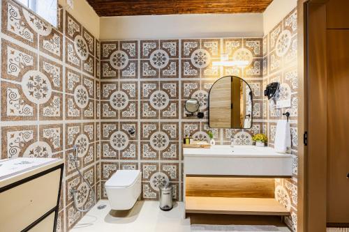 a bathroom with a toilet and a sink at ELIVAAS Heaven in Hills Mountara 3 BHK Villa with Lounge & Pvt Pool in Udaipur