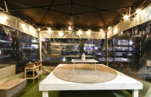 a room with a white table in a tent at Haruae hotel in Busan