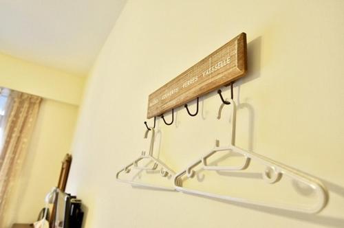 a towel rack on a wall with a wooden board at Village Villa B&B in Zhuqi