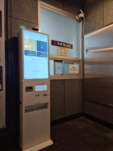 a machine with a screen in the corner of a room at Haruae hotel in Busan