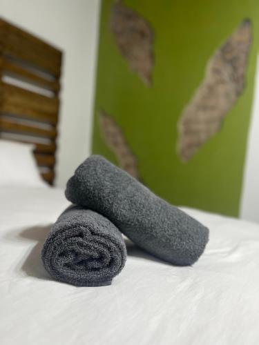 a couple of towels sitting on top of a bed at Grace to Grace Guest House in Klerksdorp