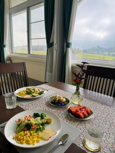 a table with three plates of food on it at Garden House Rice Field and Mountain View in Luang Prabang