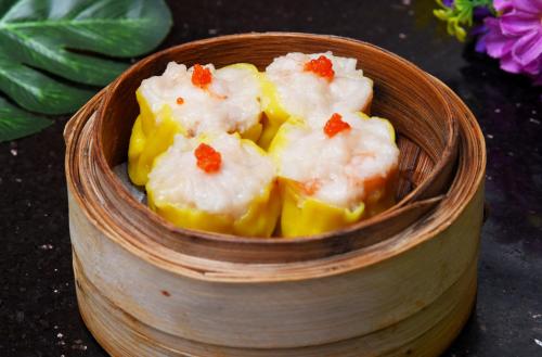 a small wooden bowl of food in a bowl at Ocean Hotel Guangzhou - Free Shuttle Bus to Canton Fair, Tao Jin railway station in Guangzhou