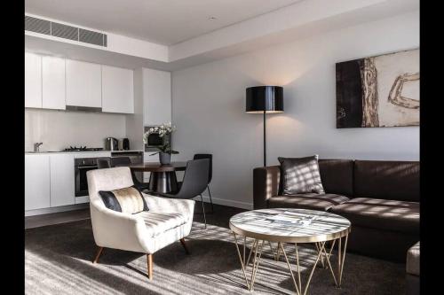 a living room with a couch and a table at Comfortable&Convenient Rental Apartment in Chatswood in Sydney