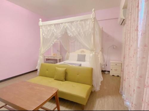a living room with a yellow couch and a bed at Village Villa B&B in Zhuqi