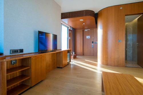 a living room with a flat screen tv on a wall at Crowne Plaza Kayseri by IHG in Kayseri