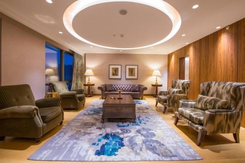 a living room with couches chairs and a table at Crowne Plaza Kayseri by IHG in Kayseri