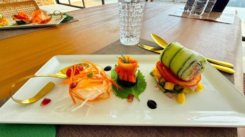 a plate of food with vegetables on a table at Anzhu Seamate Villa Samui in Amphoe Koh Samui