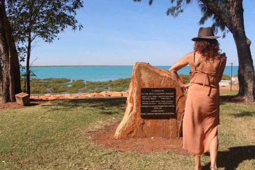 a woman in a hat standing next to a rock at Guwarri Bayside Retreat in Broome