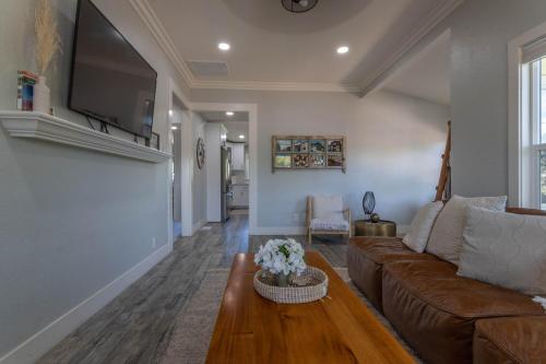 a living room with a couch and a table at Relaxing 3BR Home with Vineyard View Rooftop Deck and Game Room in Sebastopol