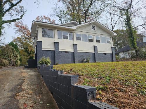 a house on a hill with a retaining wall at west midtown in Atlanta