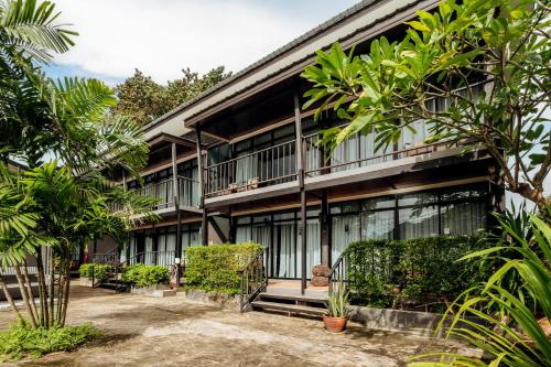 an exterior view of a building with trees at Ibiza House Phi Phi in Phi Phi Don