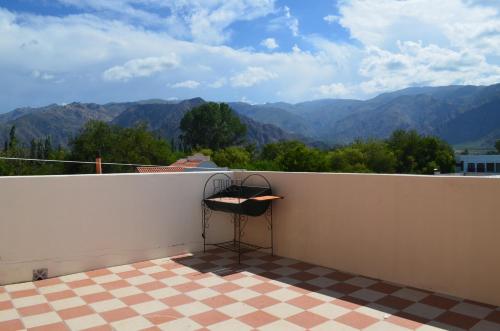 a chair on a balcony with a view of mountains at Kamay Apart Cafayate in Cafayate