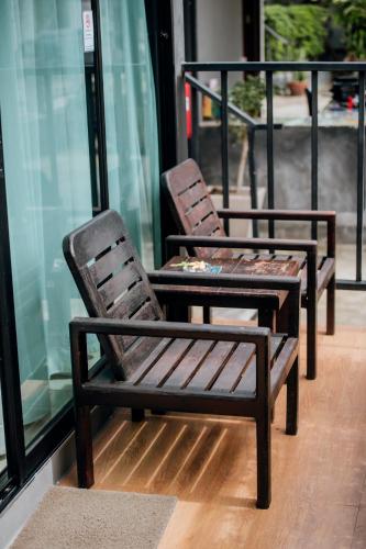 two chairs sitting in front of a window at Ibiza House Phi Phi in Phi Phi Don