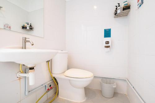 a bathroom with a white toilet and a sink at Ibiza House Phi Phi in Phi Phi Don