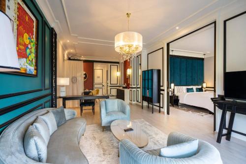 a living room with a couch and a bedroom at The Soul Resort in Sara Buri