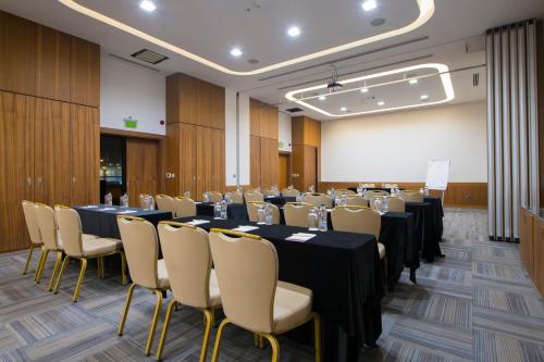 a conference room with long tables and chairs at Crowne Plaza Kayseri by IHG in Kayseri