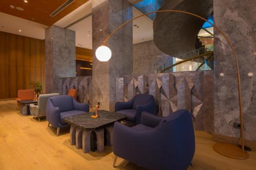 a meeting room with blue chairs and a table at Crowne Plaza Kayseri by IHG in Kayseri