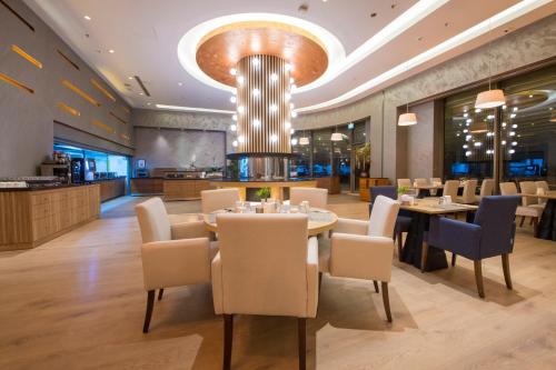 a dining room with tables and chairs and a chandelier at Crowne Plaza Kayseri by IHG in Kayseri