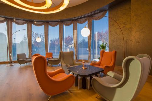 a waiting room with orange chairs and a table at Crowne Plaza Kayseri by IHG in Kayseri