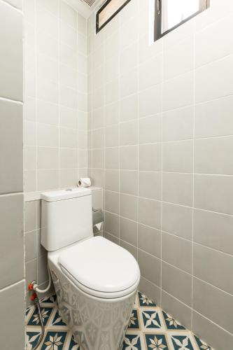 a bathroom with a white toilet in a room at Peak Elite Boutique in Siem Reap